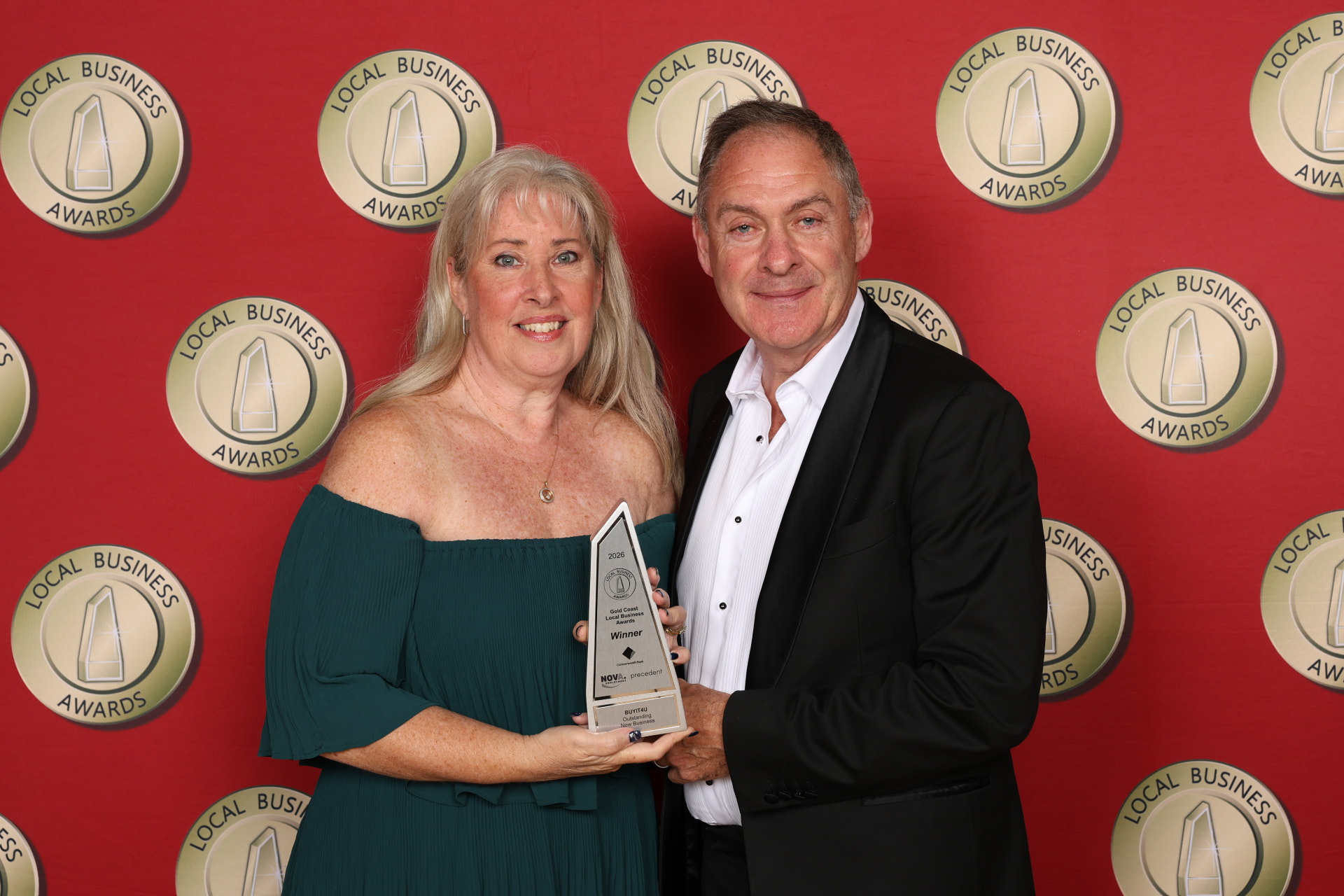 Stacey and Rob Mitchell holding the 2026 Gold Coast Local Business Awards winner trophy